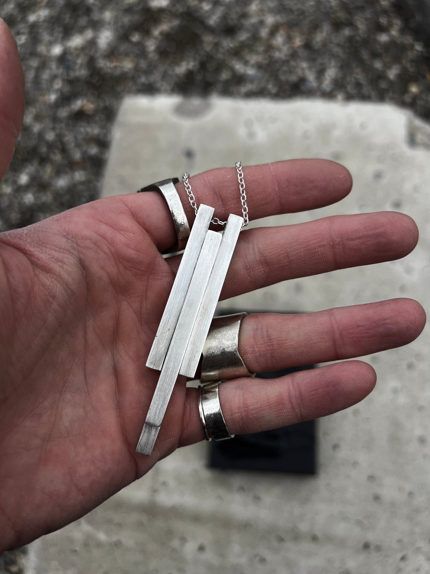 Hand-shaped, heavy pendant with brutalist character made from solid silver