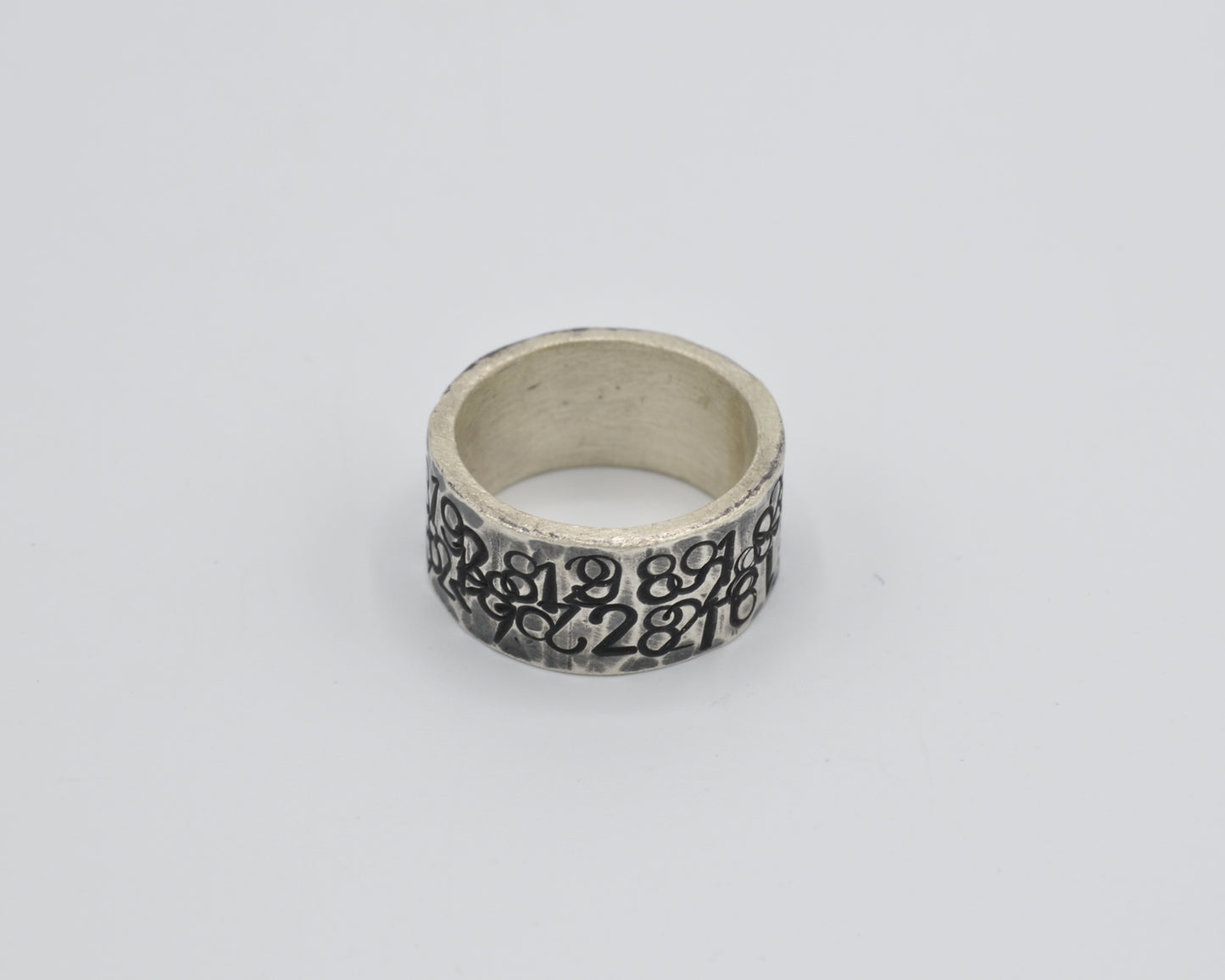 avantgarde, oxidized silver ring with numbers punched in