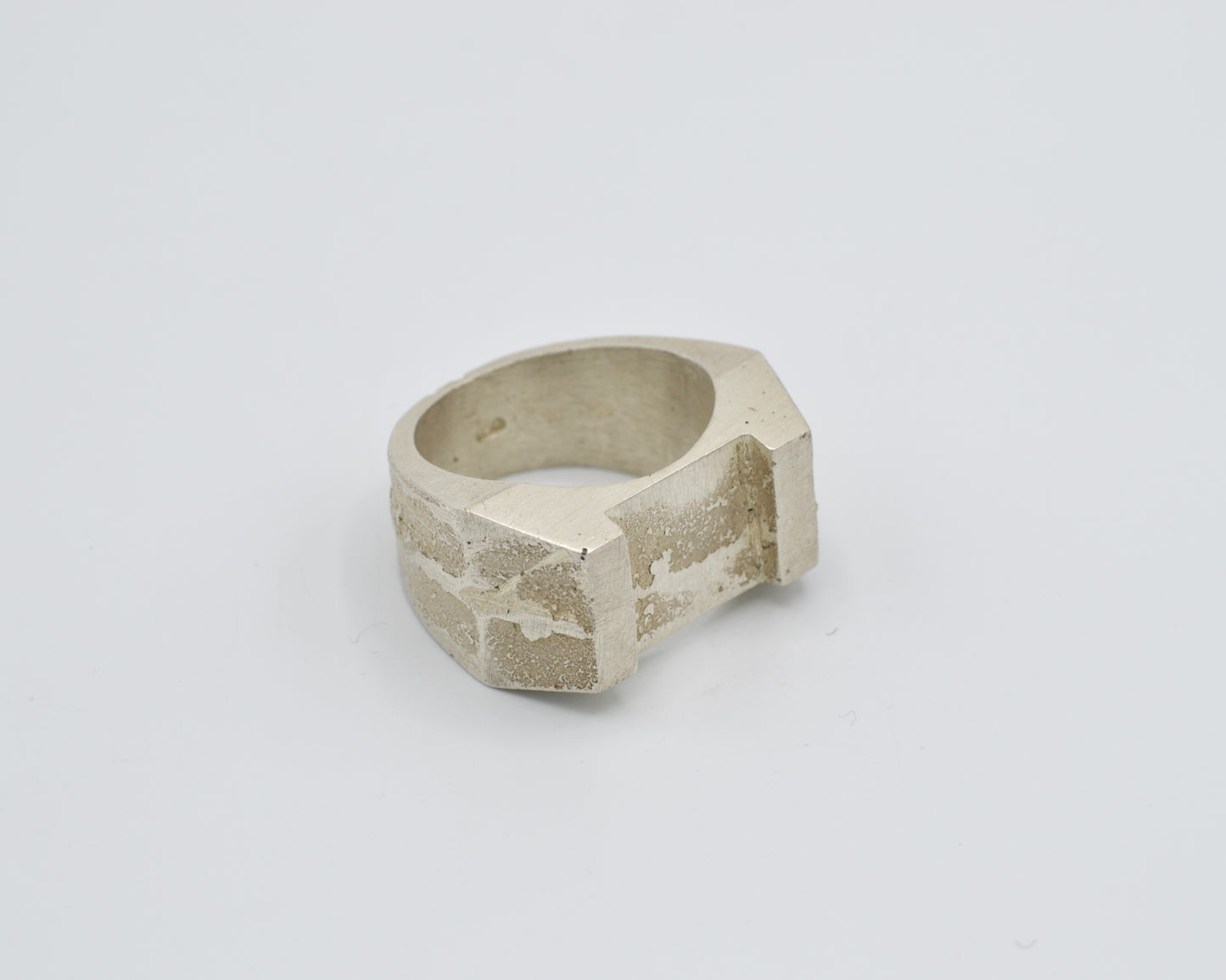 Sand cast ring with sculptural, brutalist design. Raw surface