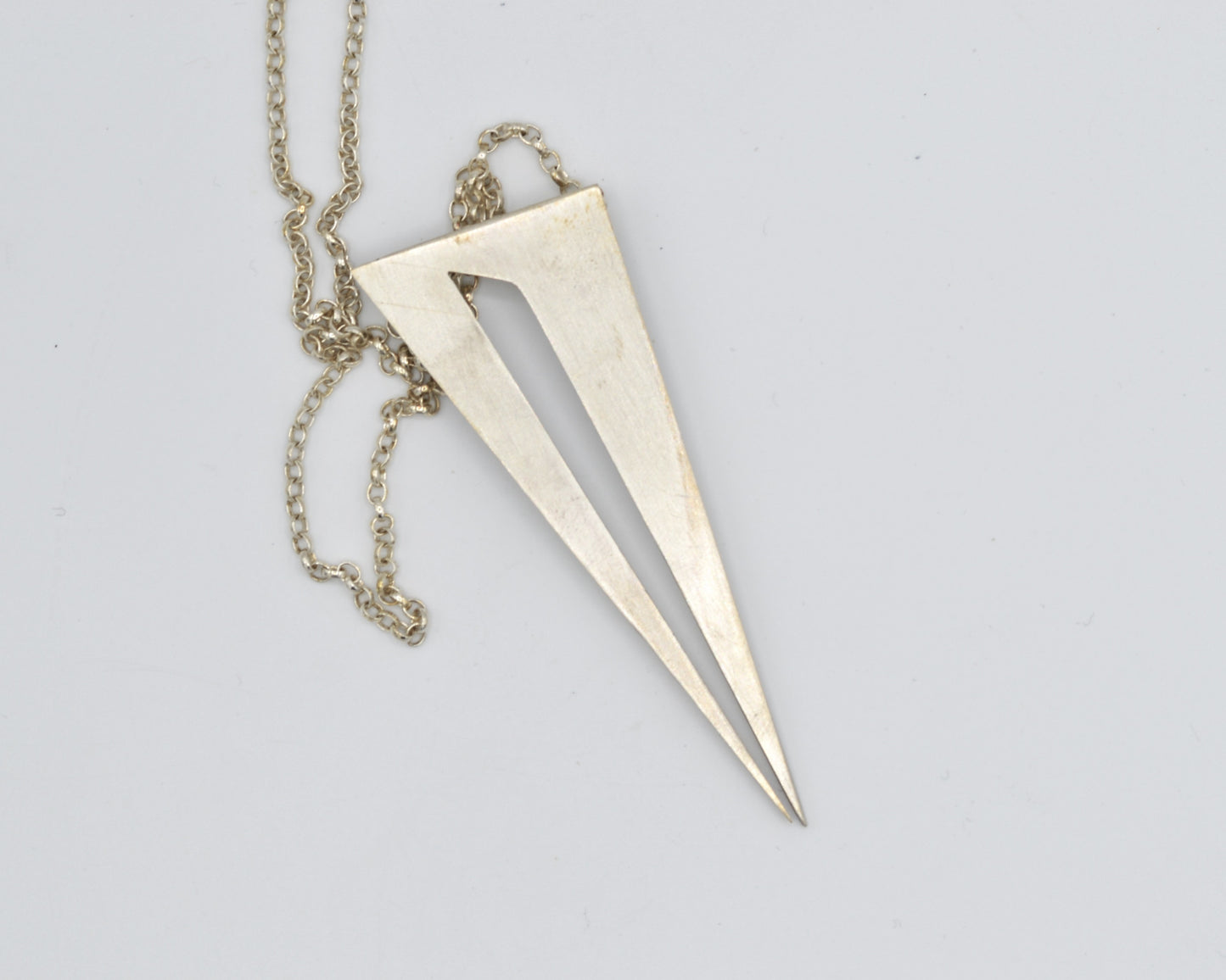 Bold pendant in 950 silver, handmade and architectural in feel with a dark, mysterious aesthetic.