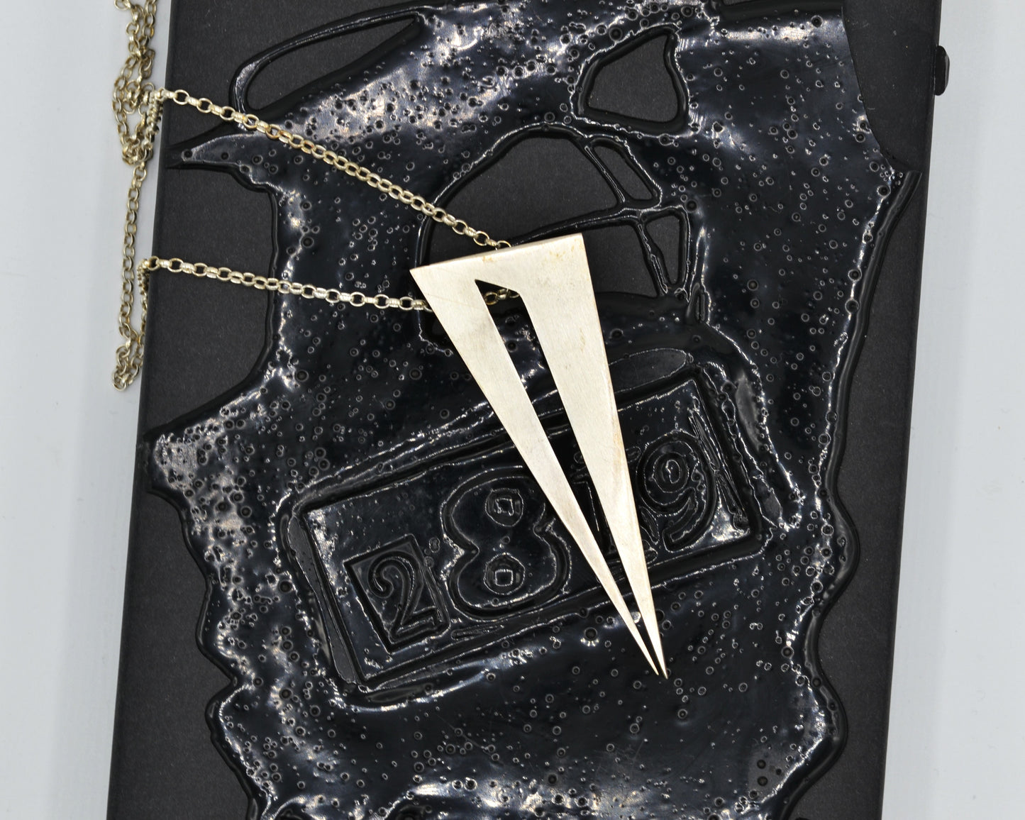 Bold pendant in 950 silver, handmade and architectural in feel with a dark, mysterious aesthetic.