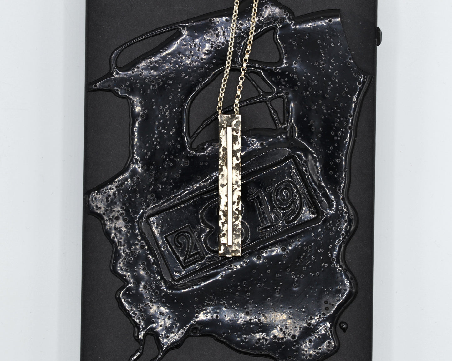 Sculptural silver necklace with rough finish, avant-garde aesthetic