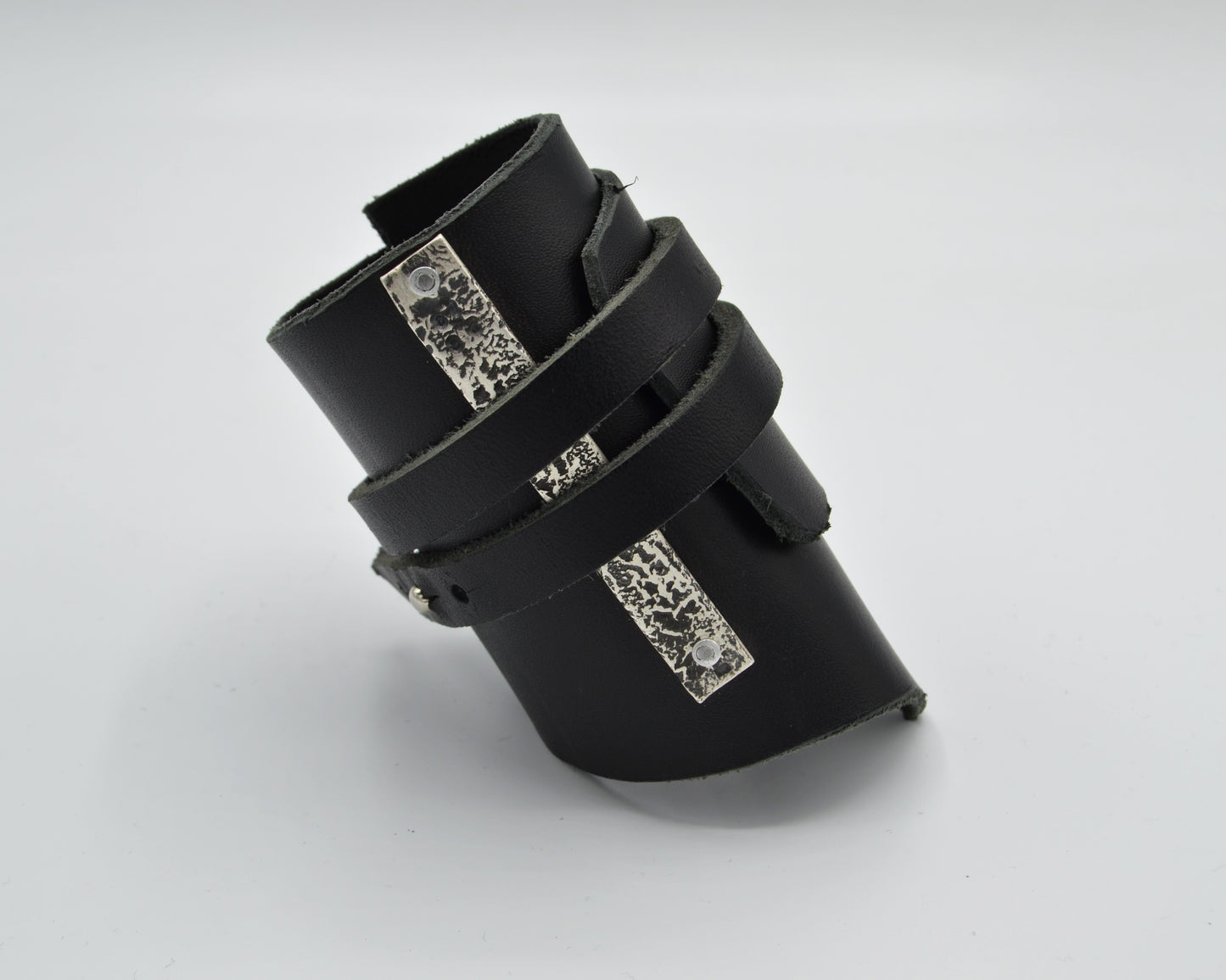 avantgarde, dark aesthetic leather bracelet with signature sterling silver plate mounted at the side.