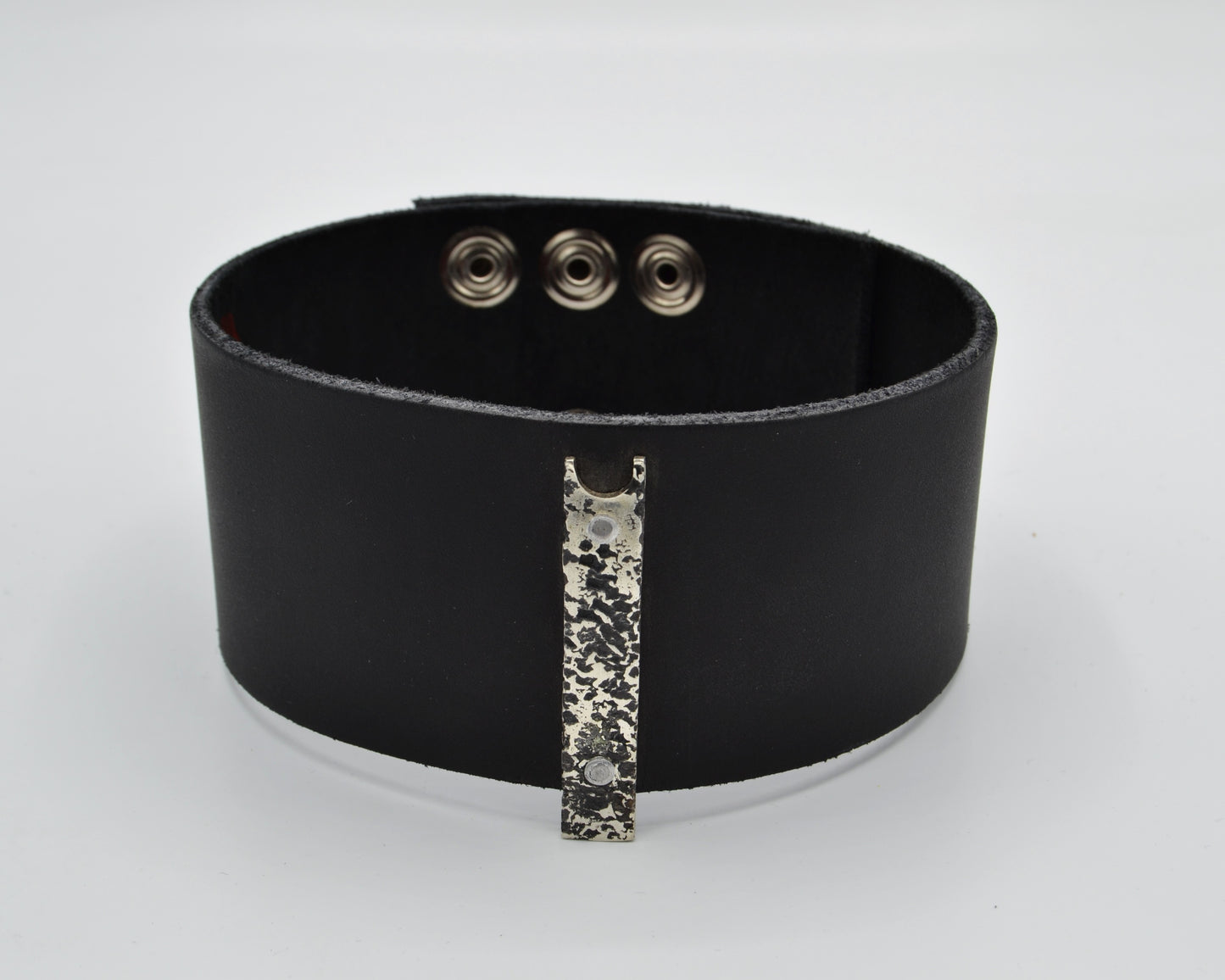 avant-garde leather choker with sterling silver plate mountred on top.
