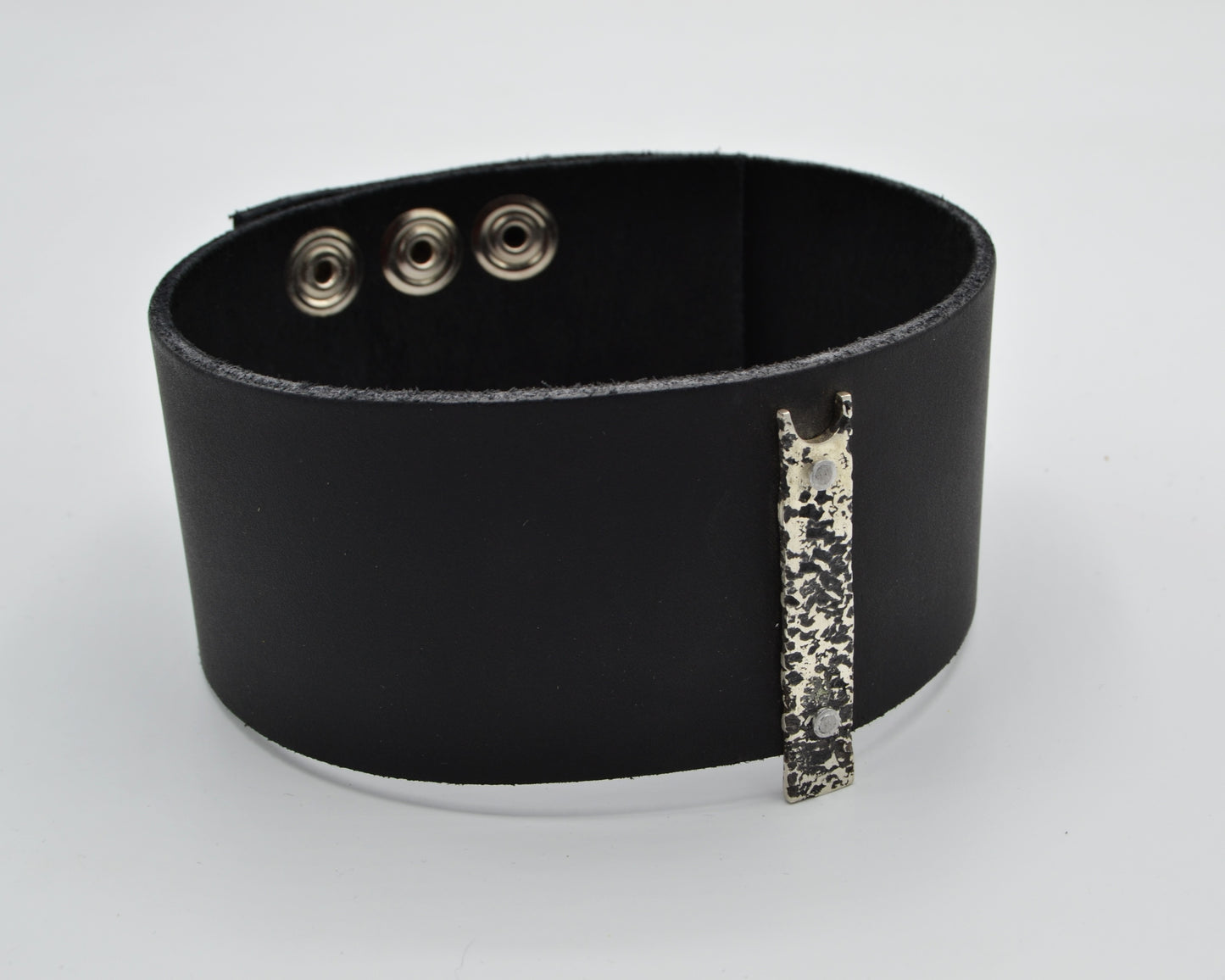 avant-garde leather choker with sterling silver plate mountred on top.
