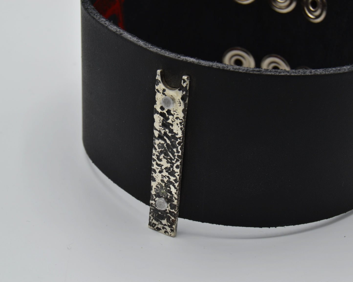 avant-garde leather choker with sterling silver plate mountred on top.