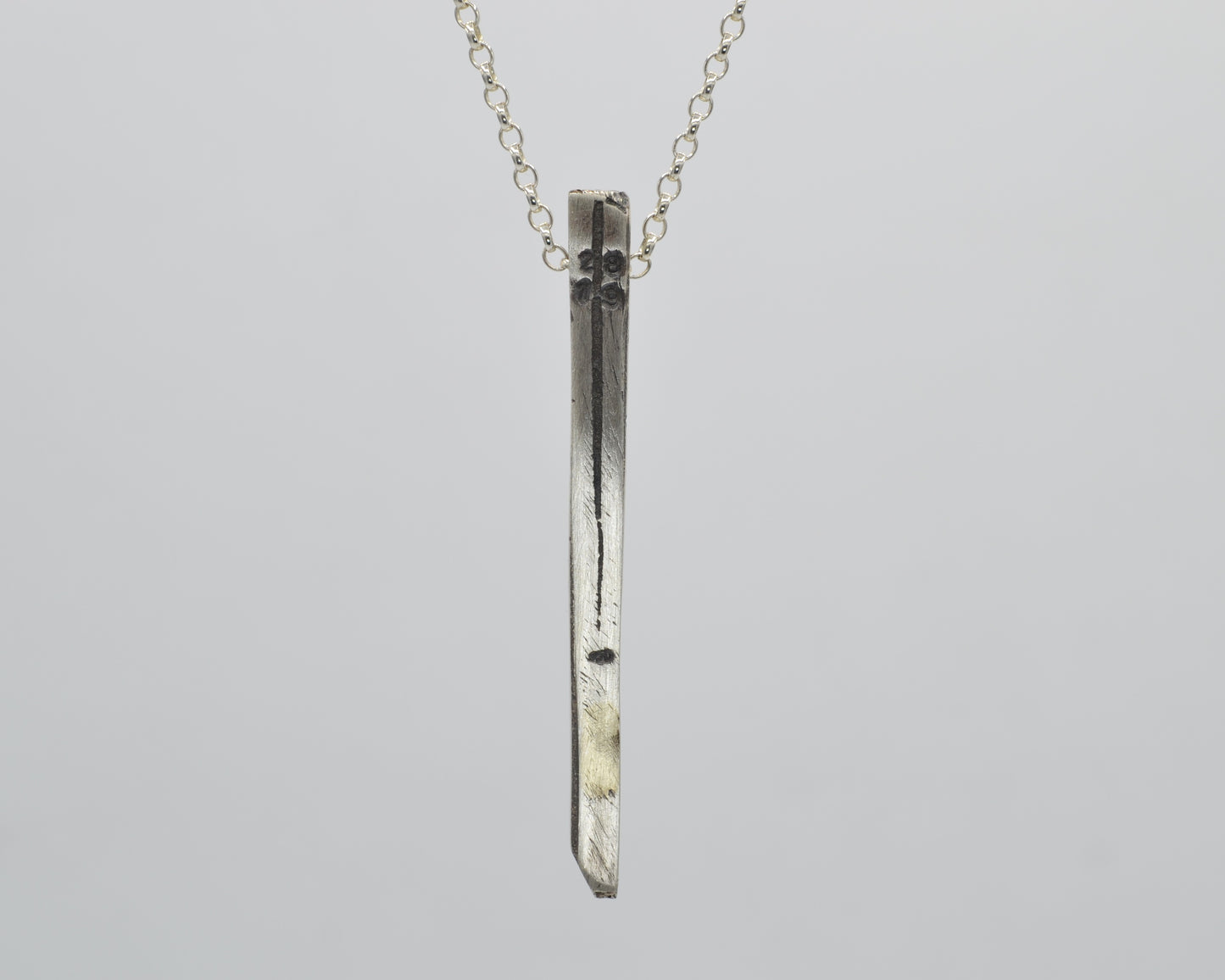 Silver pendant with textured finish, crafted with sand casting method