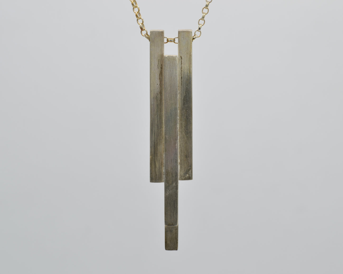 Hand-shaped, heavy pendant with industrial character made from solid silver