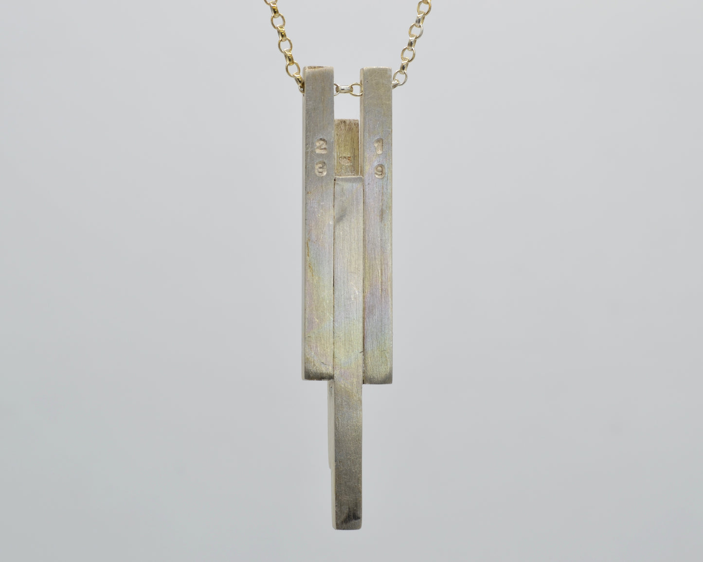 Hand-shaped, heavy pendant with brutalist character made from solid silver