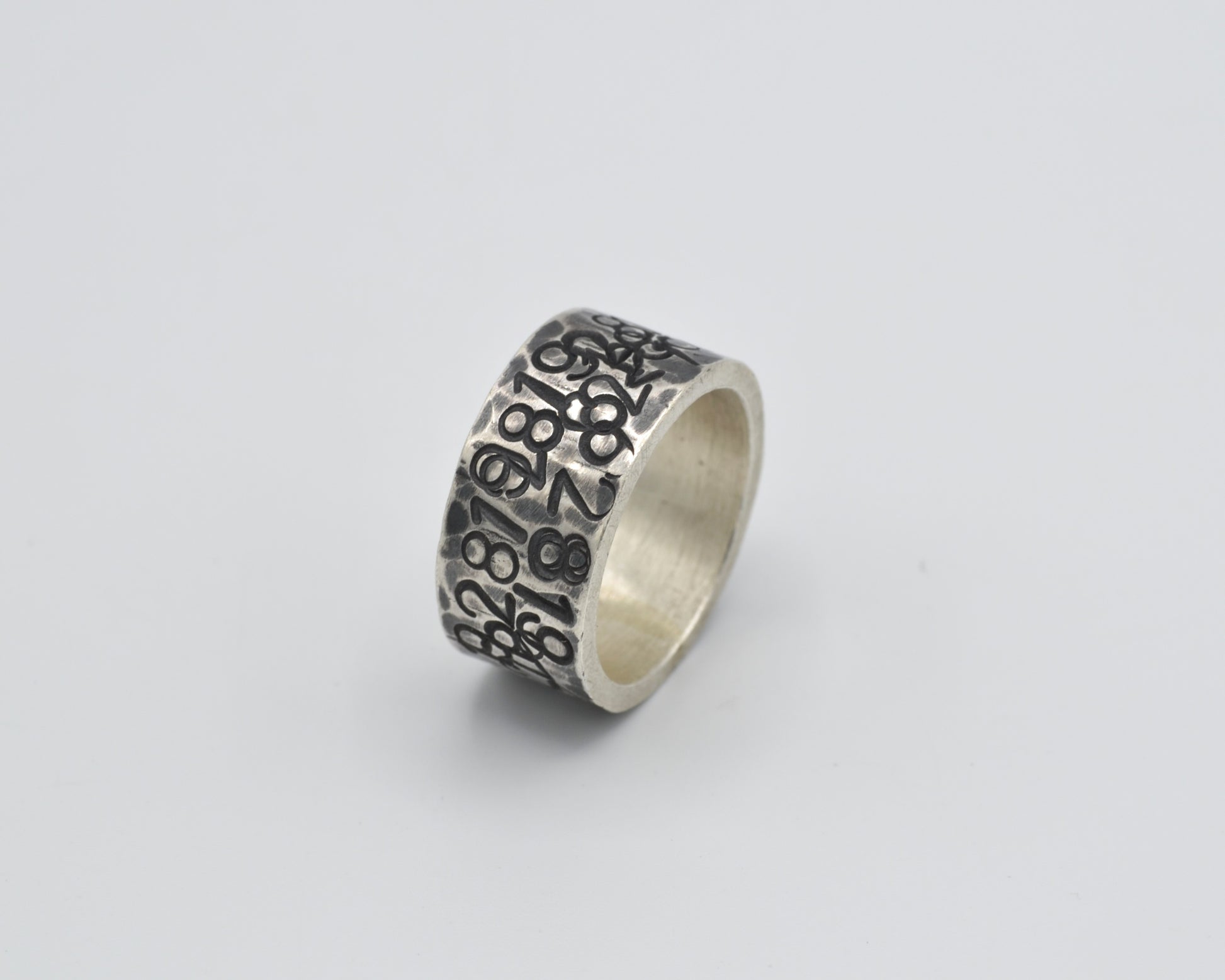 avantgarde, oxidized silver ring with numbers punched in