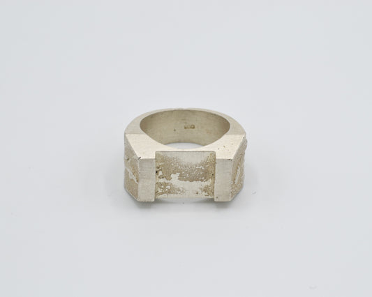 Sand cast ring with sculptural, brutalist design. Raw surface