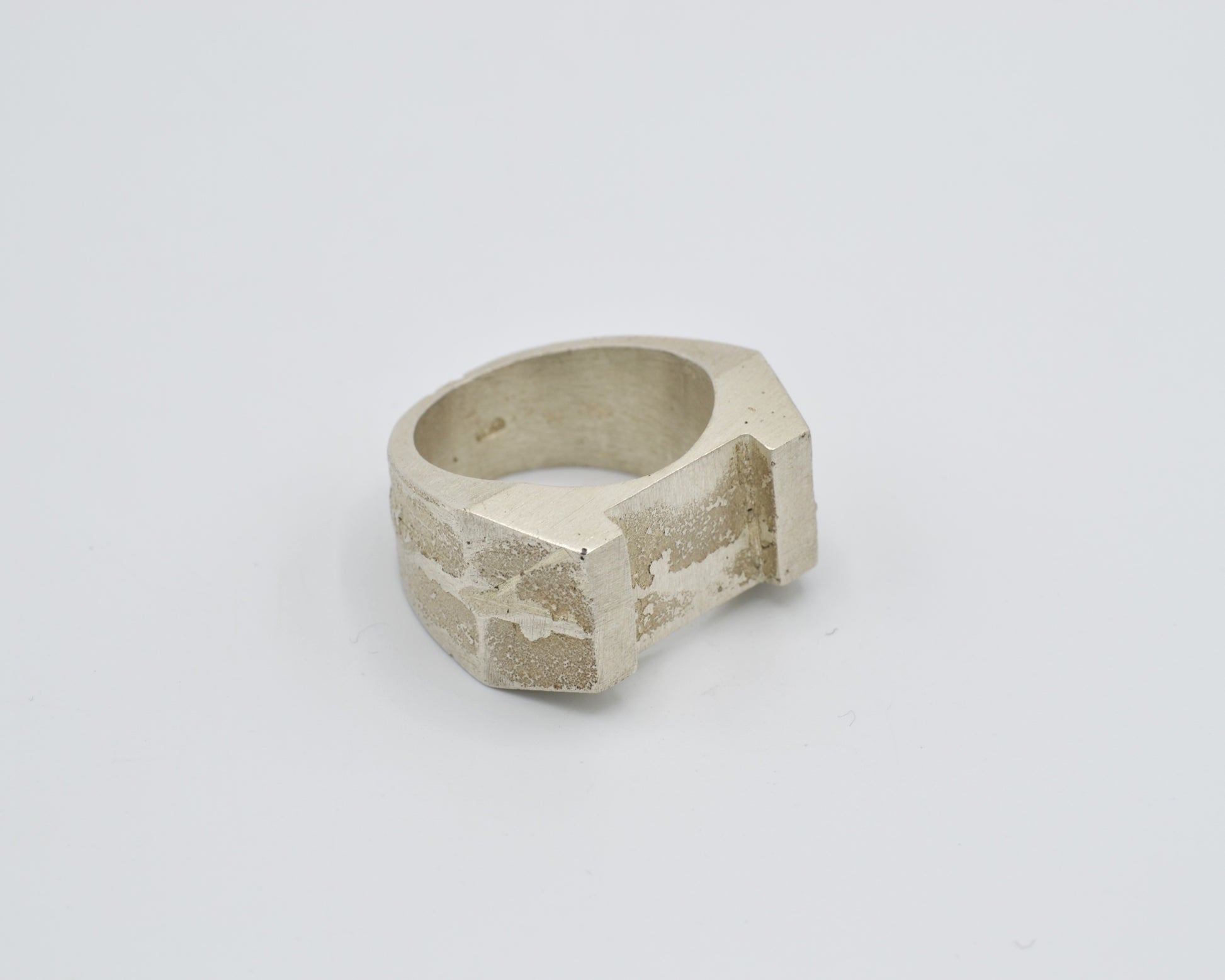 Sand cast ring with sculptural, brutalist design. Raw surface