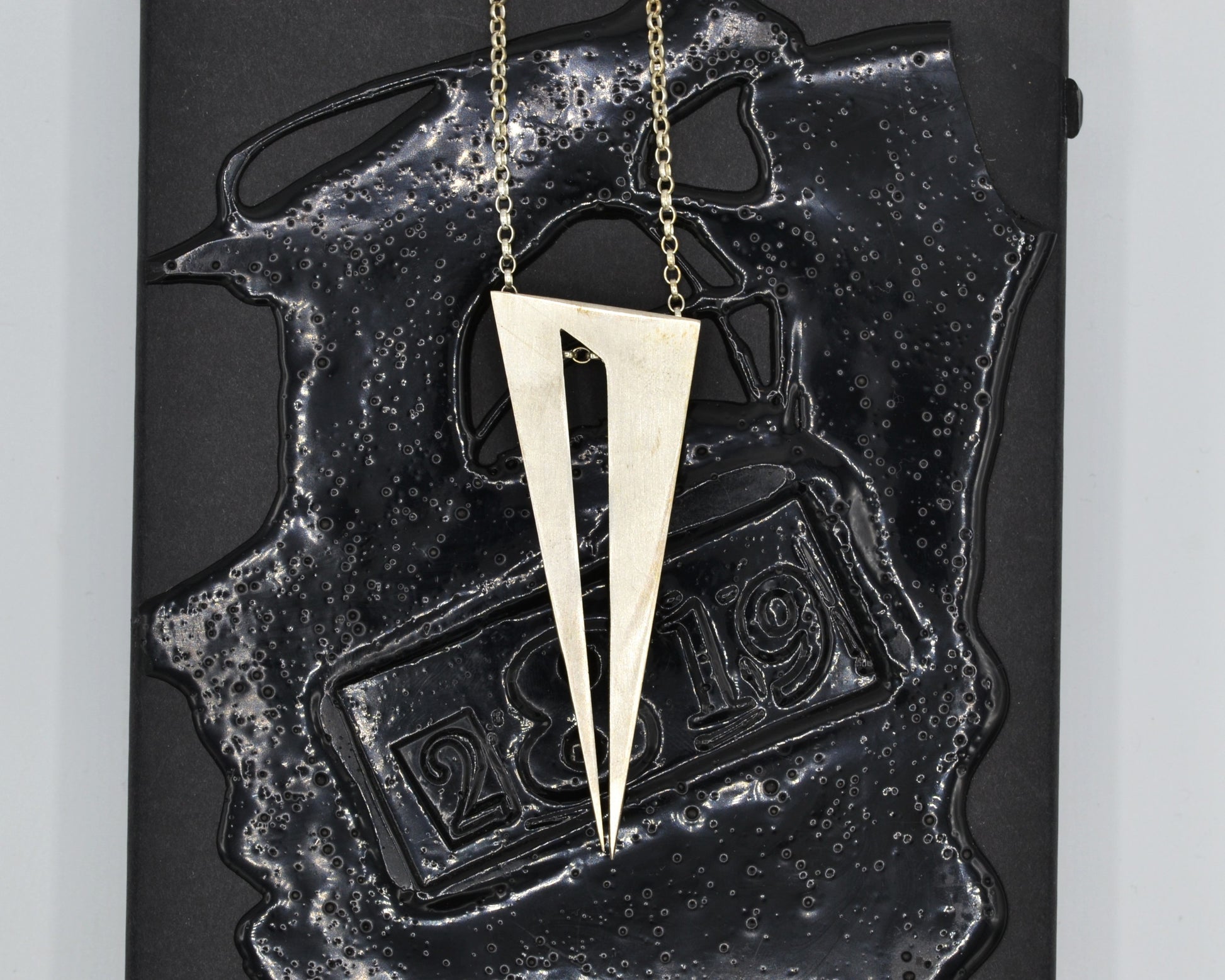 Bold pendant in 950 silver, handmade and architectural in feel with a dark, mysterious aesthetic.