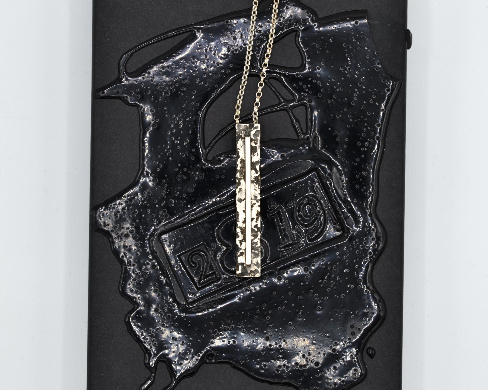 Sculptural silver necklace with rough finish, avant-garde aesthetic