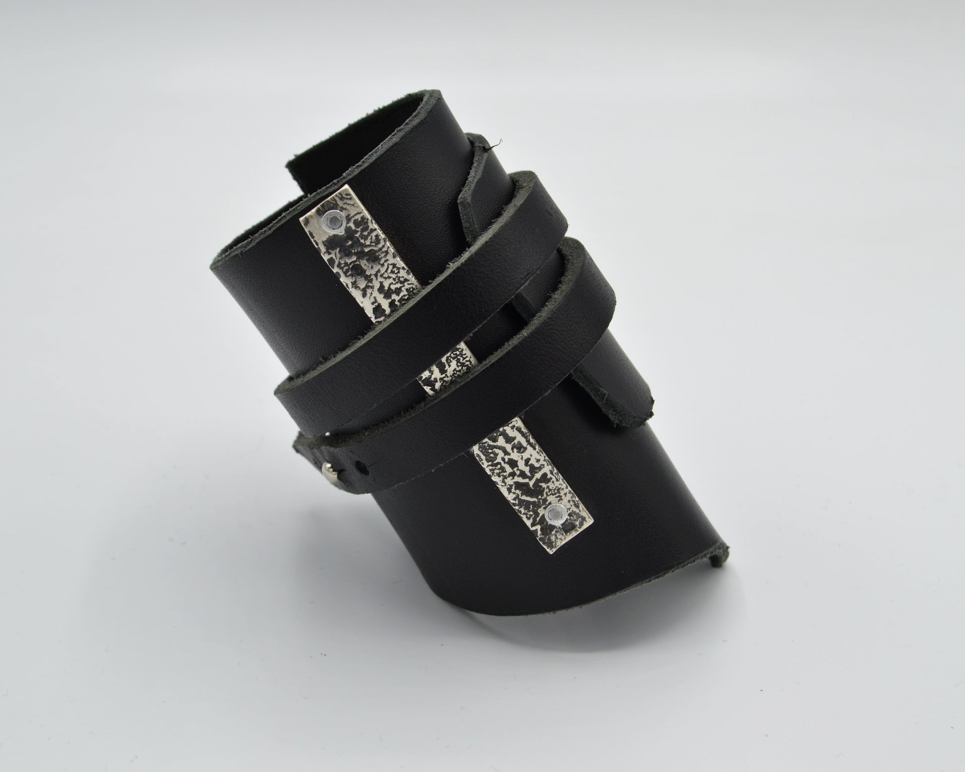 avantgarde, dark aesthetic leather bracelet with signature sterling silver plate mounted at the side.