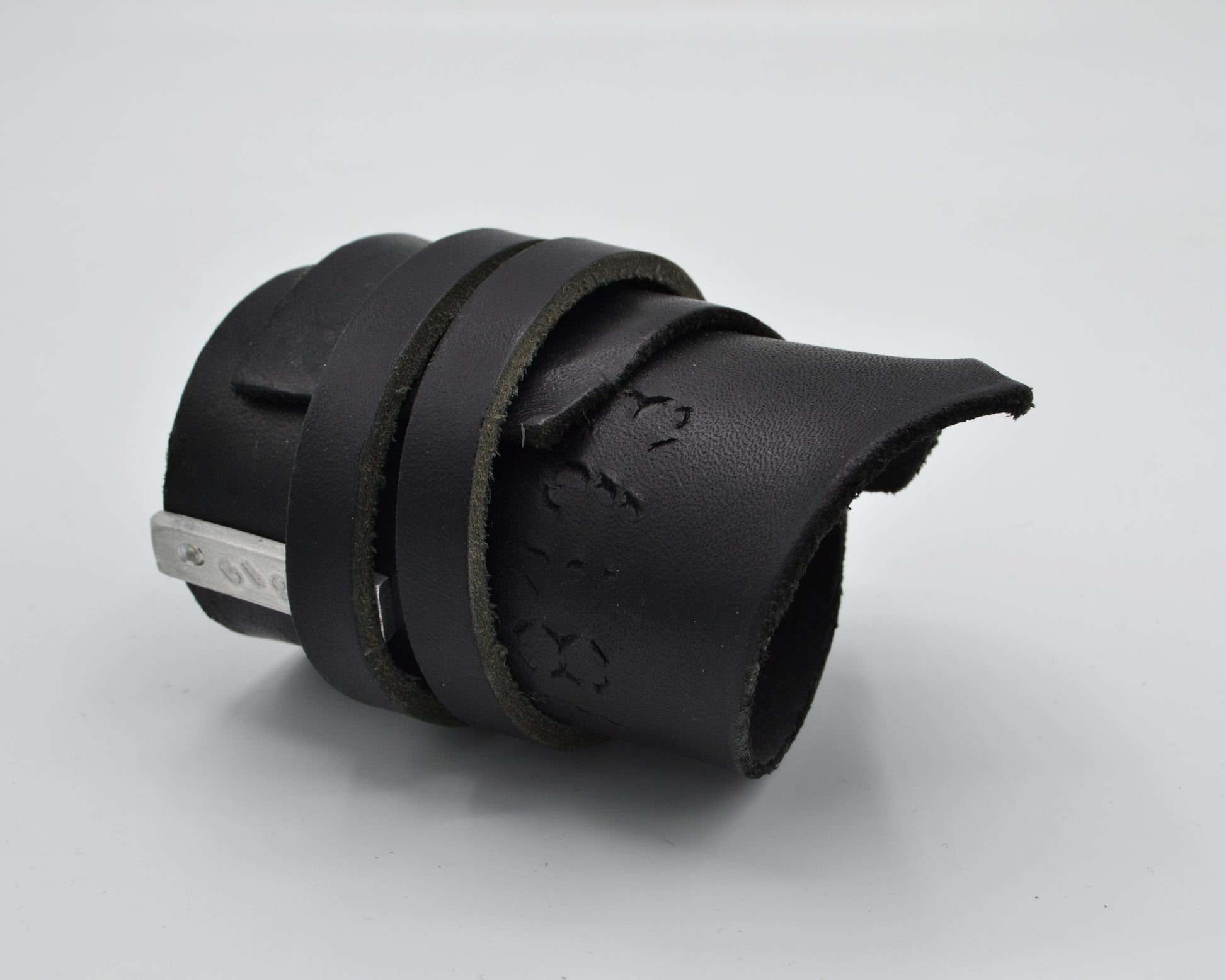 avantgarde, dark aesthetic leather bracelet with small aluminum plate mounted at the side.