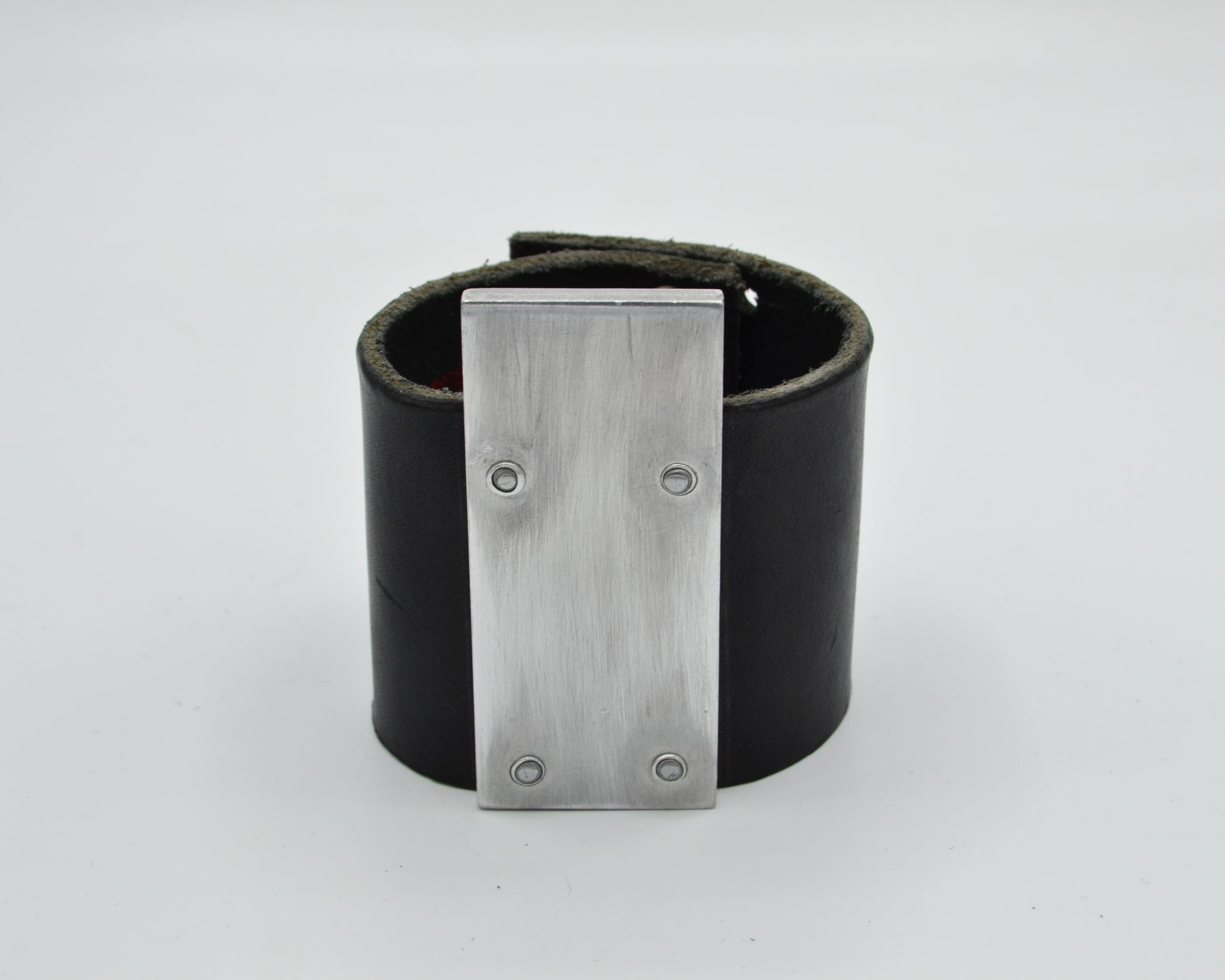 avantgarde, brutalist leather bracelet with aluminum plate mounted on top. 