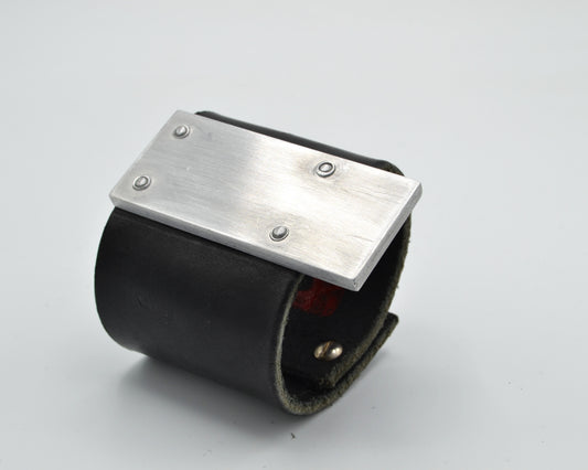 avantgarde, brutalist leather bracelet with aluminum plate mounted on top. 