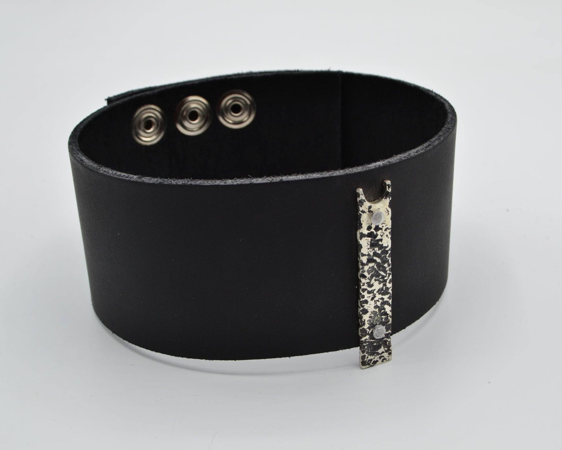 avant-garde leather choker with sterling silver plate mountred on top.