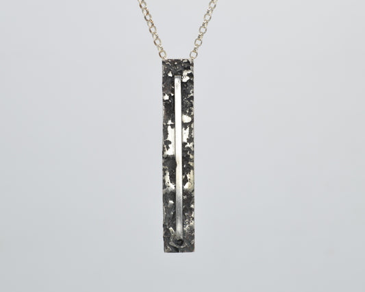 Sculptural silver necklace with rough finish, avant-garde aesthetic