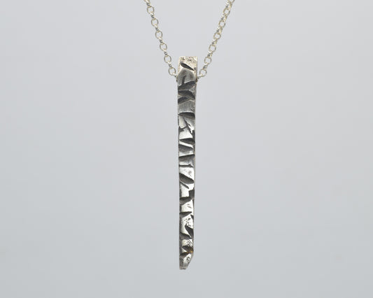 Silver pendant with textured finish, crafted with sand casting method