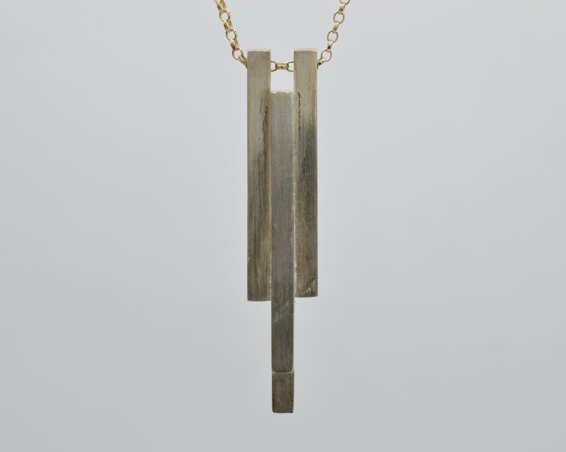 Hand-shaped, heavy pendant with industrial character made from solid silver
