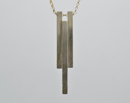 Hand-shaped, heavy pendant with industrial character made from solid silver